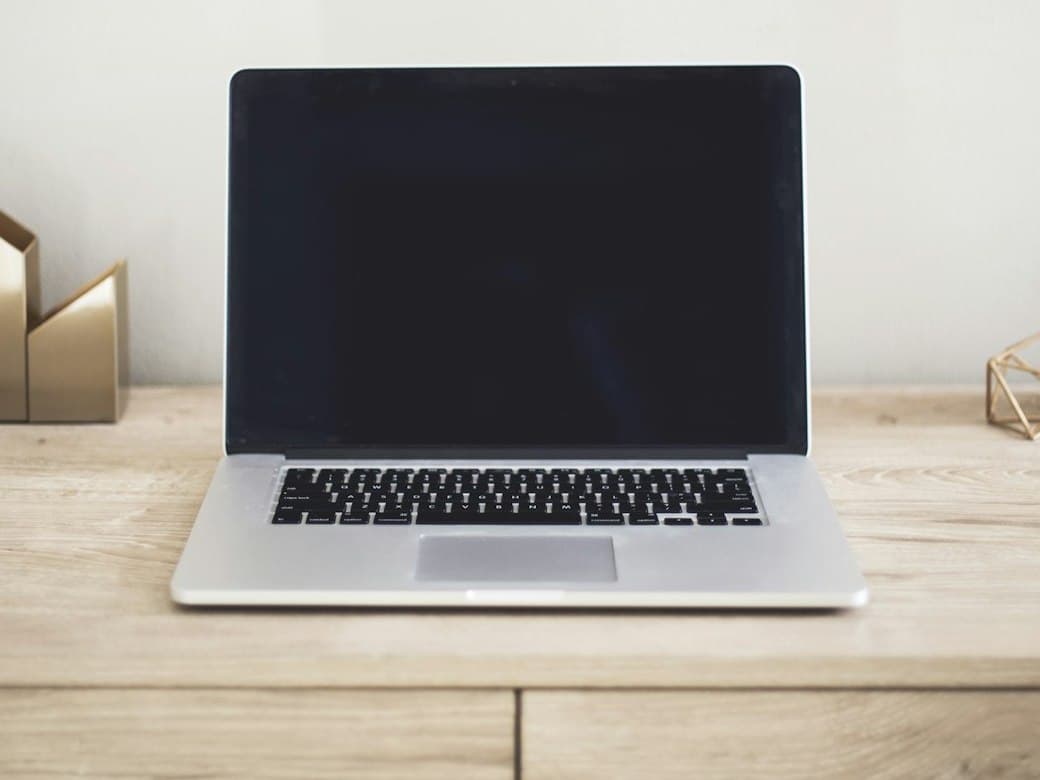 Clean laptop open on a tidy wooden desk